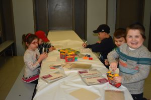 Group of Children Coloring Pictures at Chanuka Party